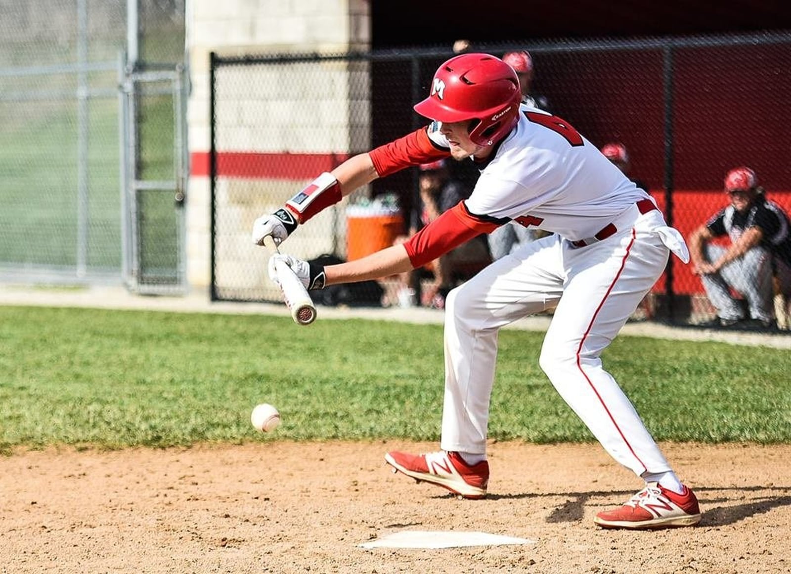 Madison’s Jake Edwards puts down a sacrifice bunt during Thursday’s game against Carlisle in Madison Township. NICK GRAHAM/STAFF