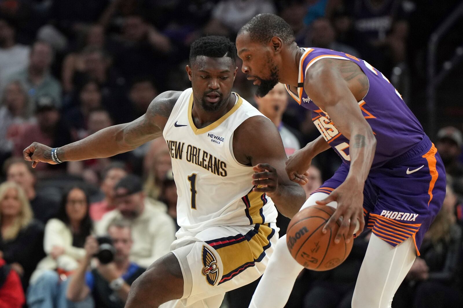 New Orleans Pelicans forward Zion Williamson (1) pressures Phoenix Suns forward Kevin Durant during the first half of an NBA basketball game, Thursday, Feb. 27, 2025, in Phoenix. (AP Photo/Rick Scuteri)