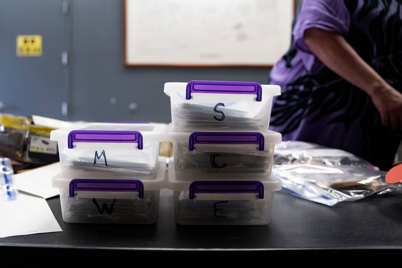 Containers of lists and photographs from each location of "Two by Twos" conventions organized by Pam Waltons are pictured at a library, Monday, Dec. 9, 2024, in Wailea, Hawaii. (AP Photo/Mengshin Lin)