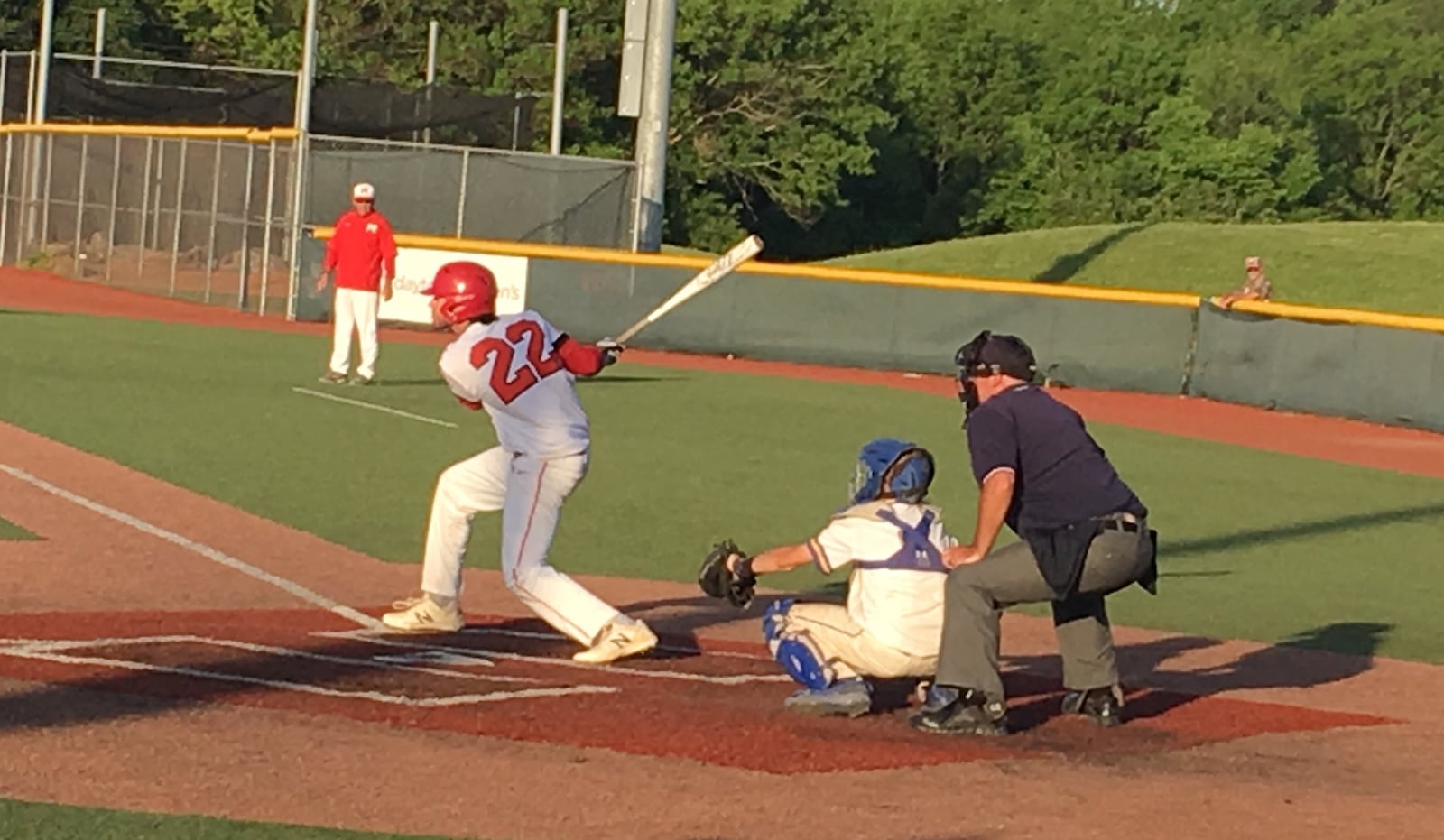 Madison’s Ben Paarlberg takes a cut during Thursday night’s Division III regional semifinal against Madeira at the Athletes in Action complex in Xenia. RICK CASSANO/STAFF