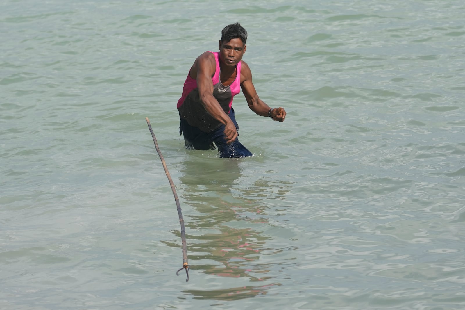 Tawan Klathale demonstrates to throw a spear to hunt fish for tourists in Moken village at Surin Islands in Phang Nga Province, Thailand, Wednesday, Dec. 11, 2024. (AP Photo/Sakchai Lalit)