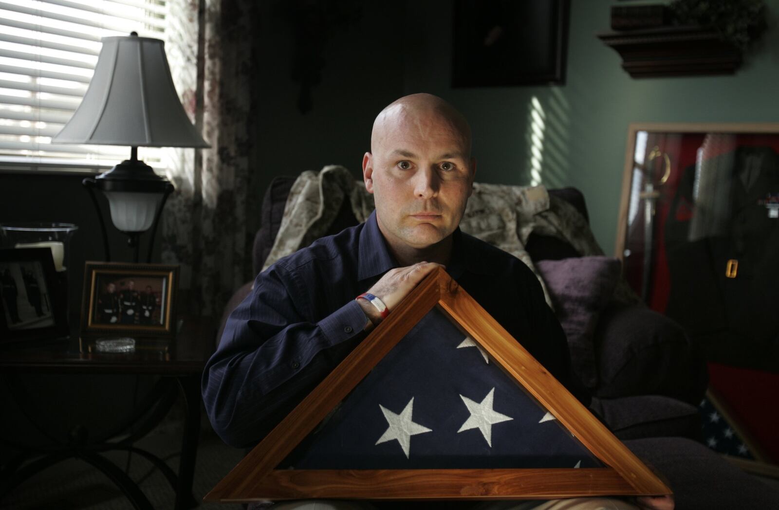 John Prazynski, father of slain soldier, Lance Cpl. Taylor Prazynski, holds the flag that was draped over his son’s casket.