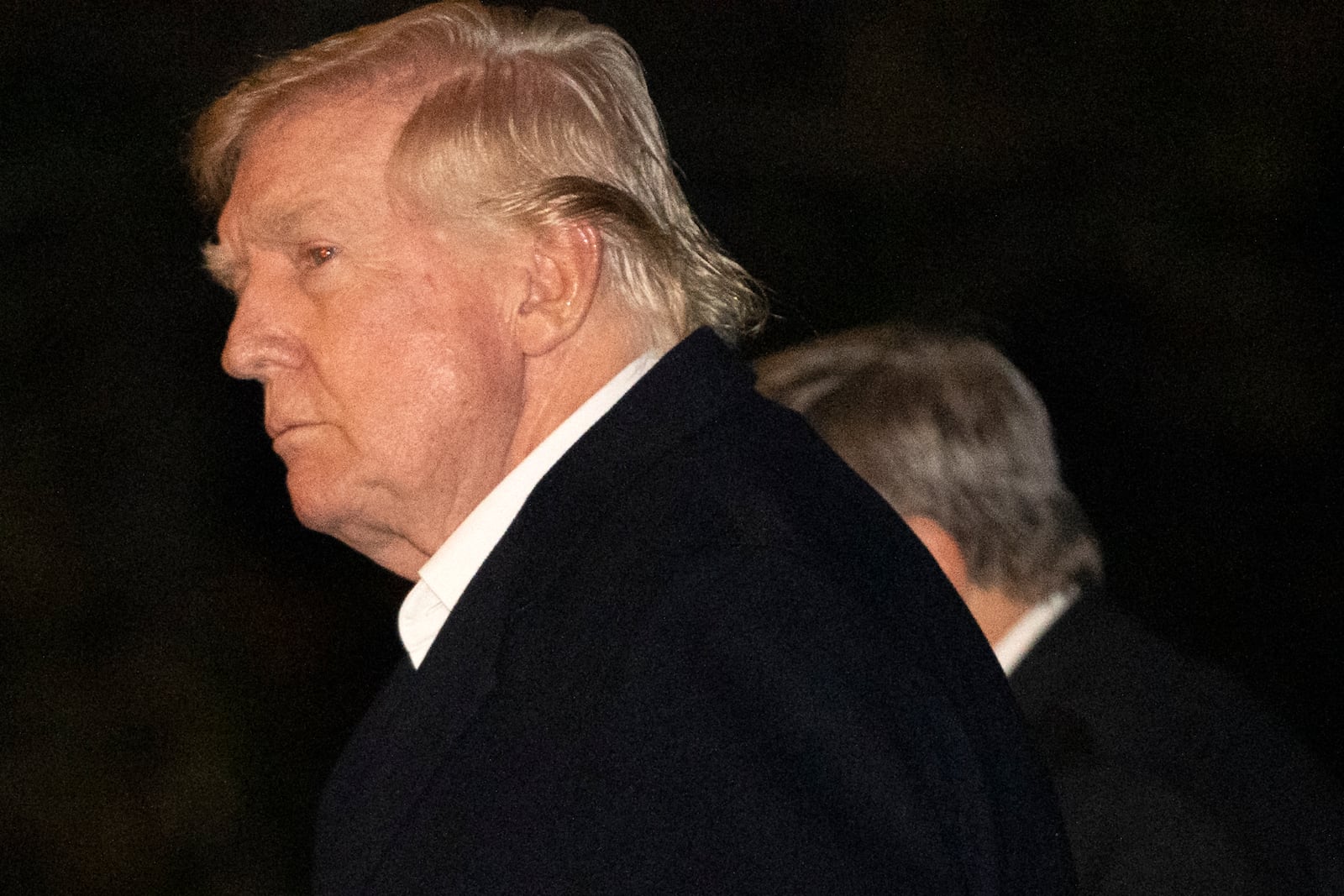 President Donald Trump walks across the South Lawn of the White House, Sunday, March 2, 2025, in Washington, after returning from a trip to Florida. (AP Photo/Mark Schiefelbein)