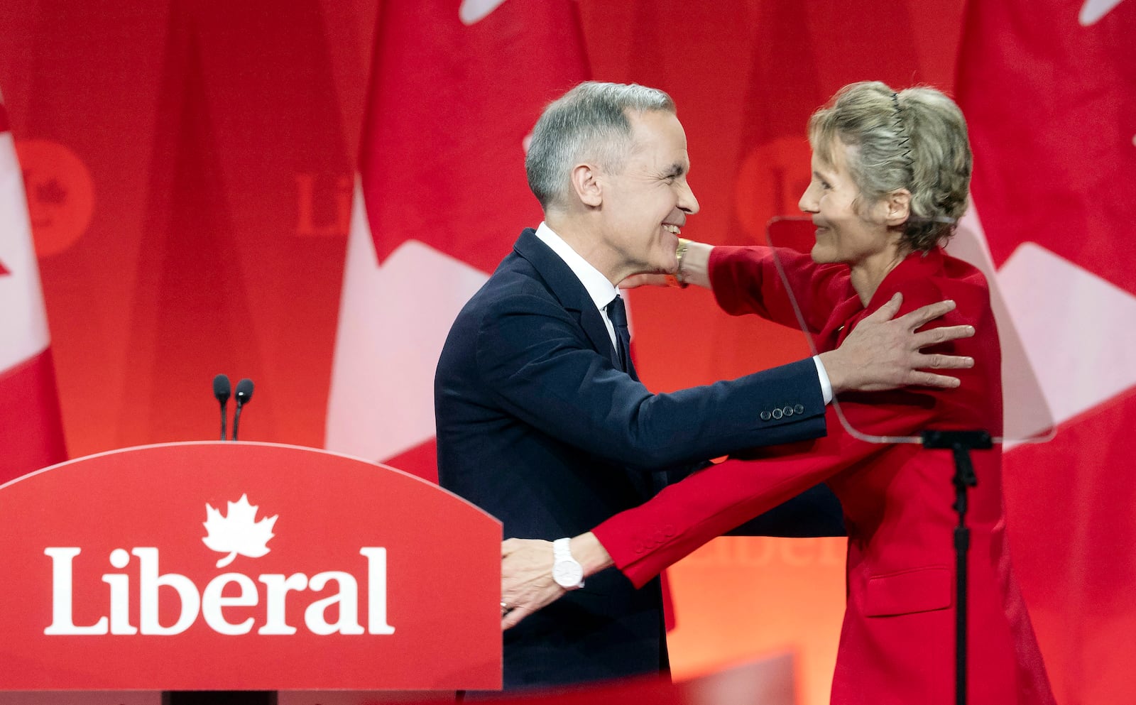 Newly appointed Liberal Leader Mark Carney hugs his wife Diana Fox Carney following his speech at the Liberal leadership announcement in Ottawa, Ontario, Sunday, March 9, 2025. (Adrian Wyld/The Canadian Press via AP)