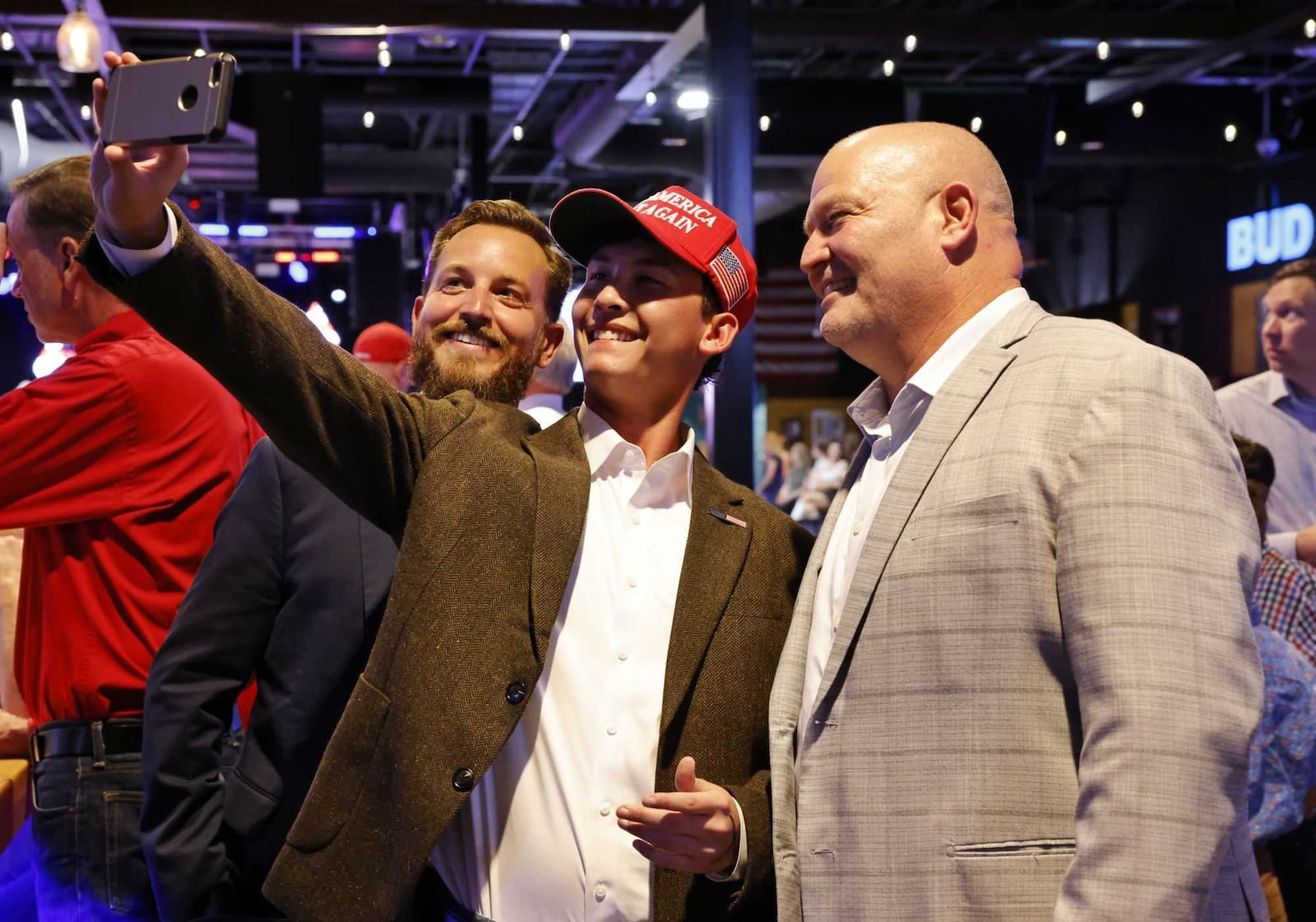 Ben Nguyen, 17, a Lakota West senior, middle, takes a selfie with Hamilton city council members Michael Ryan, left, and Joel Lauer during the Butler County Republican Party election results watch party Tuesday, Nov. 5, 2024 at Lori's Roadhouse in West Chester Township. NICK GRAHAM/STAFF