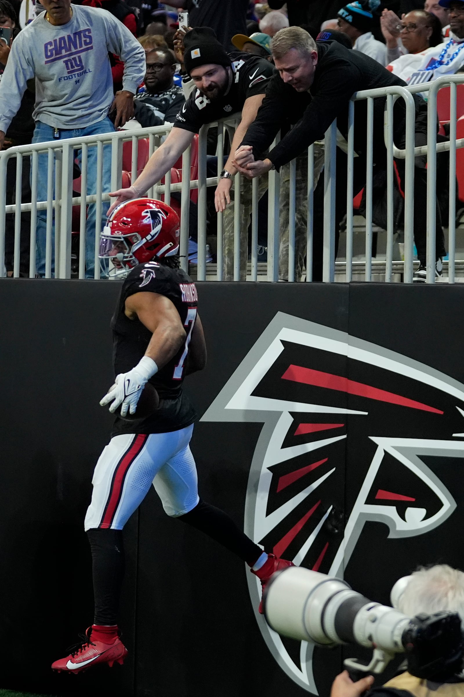 Atlanta Falcons running back Bijan Robinson (7) celebrates after a touchdown in the second half of an NFL football game against the New York Giants in Atlanta, Sunday, Dec. 22, 2024. (AP Photo/John Bazemore)