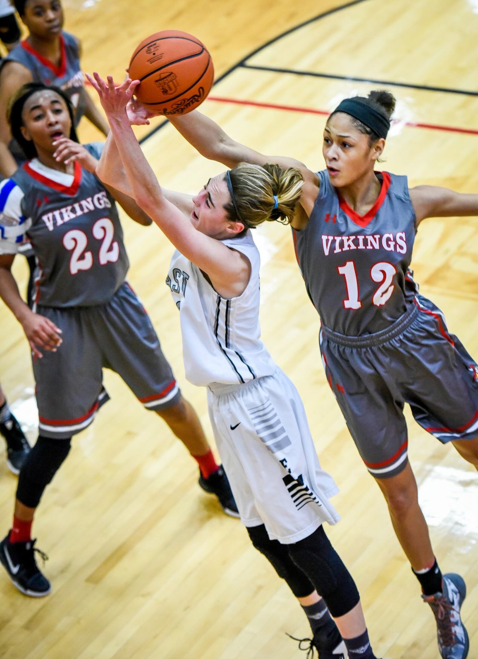 Lakota East’s Danni Stoughton is defended by Princeton’s Aja Knott as she takes a shot during their Division I sectional game Feb. 22, 2017, at Lakota West. NICK GRAHAM/STAFF