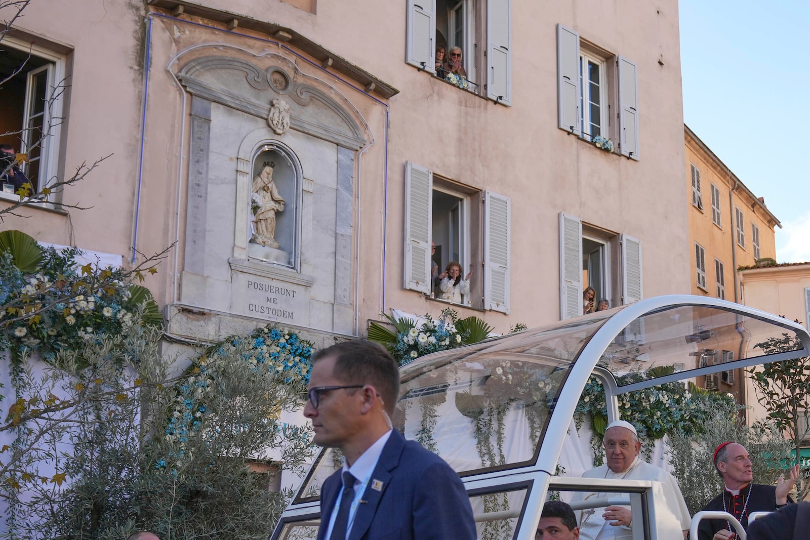 Pope Francis greets faithful after praying in for to f the statue of the Virgin Mary in Ajaccio on the occasion of his one-day visit in the French island of Corsica, Sunday, Dec. 15, 2024. (AP Photo/Alessandra Tarantino)