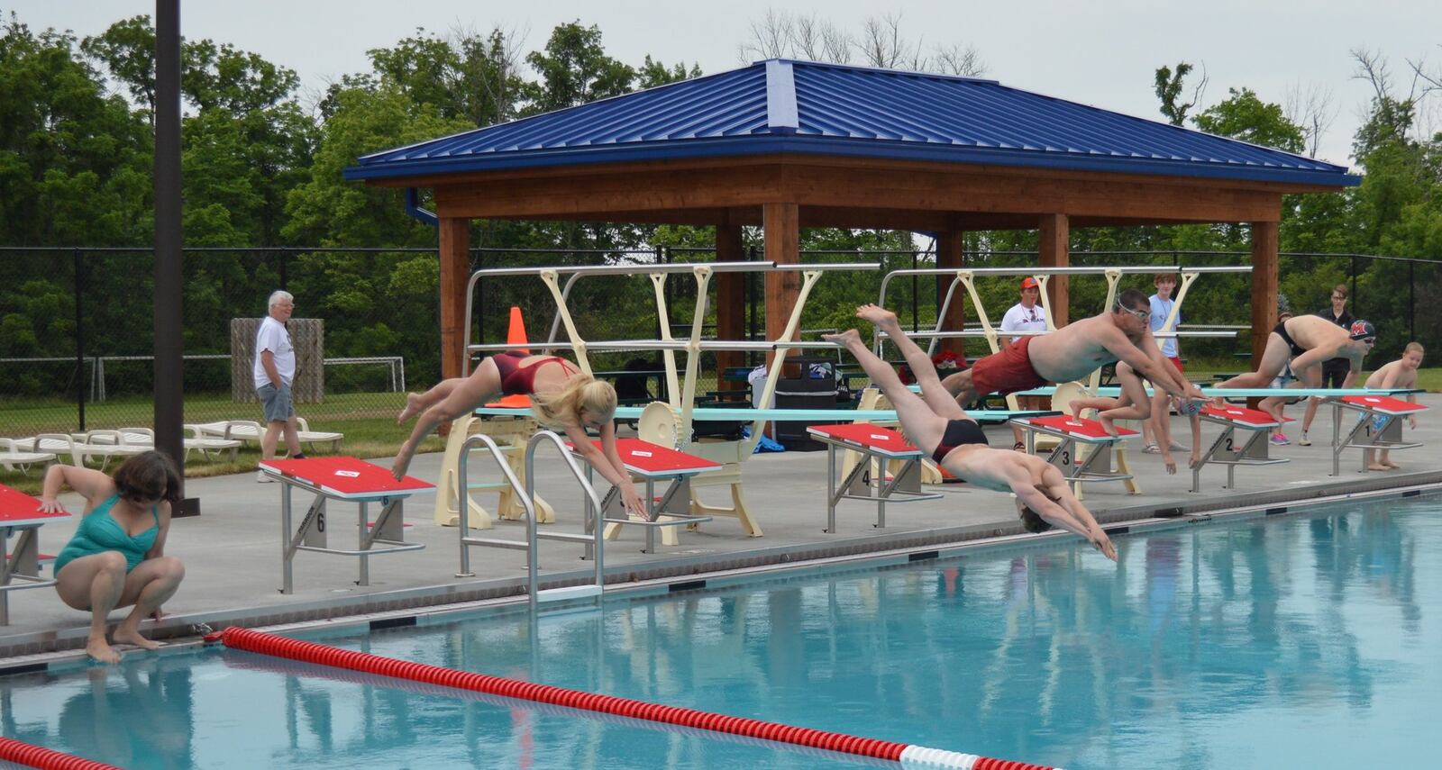 On a day of firsts, members of the Oxford Swimming and Diving team and Coach Steve Pasquale, as well as City Council member Edna Southard took part in the first lap in the new competition pool. CONTRIBUTED/BOB RATTERMAN