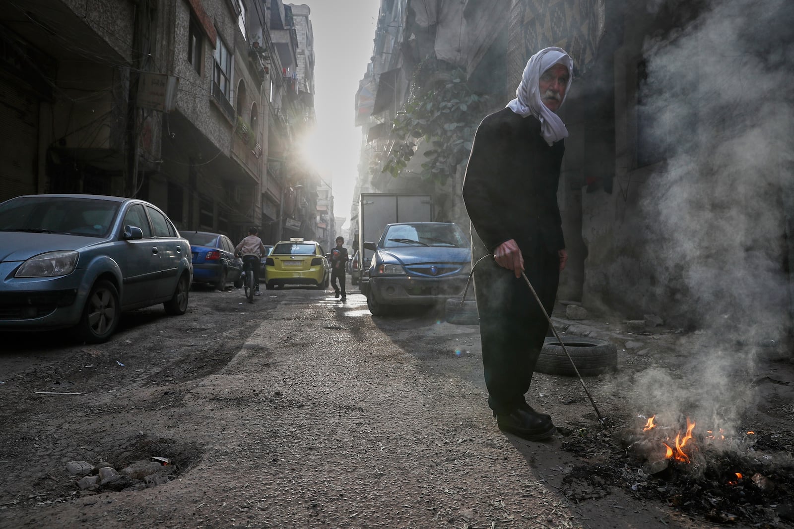 An elderly Druze man burns garbage in the town of Jaramana, in the southern outskirts of Damascus, Syria, March 3, 2025. (AP Photo/Omar Sanadiki)