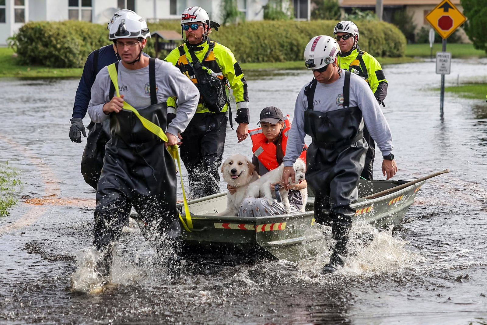 Amy Bishop is evacuated from her home by Pasco County Fire and Rescue and Sheriff's Office teams as waters rise in her neighborhood after Hurricane Milton caused the Anclote River to flood, Friday, Oct. 11, 2024, in New Port Richey, Fla. (AP Photo/Mike Carlson)