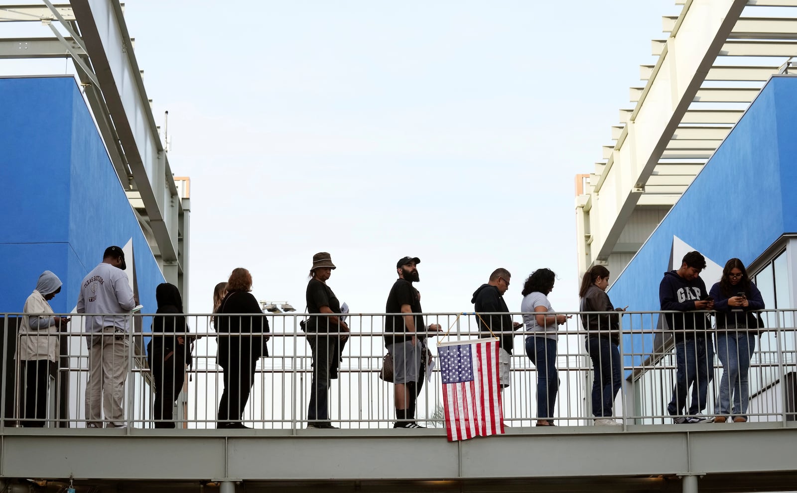 Voters wait in a long line at a polling place at the Michelle and Barack Obama Sports Complex on Election Day, Tuesday, Nov. 5, 2024, in Los Angeles. (AP Photo/Chris Pizzello)