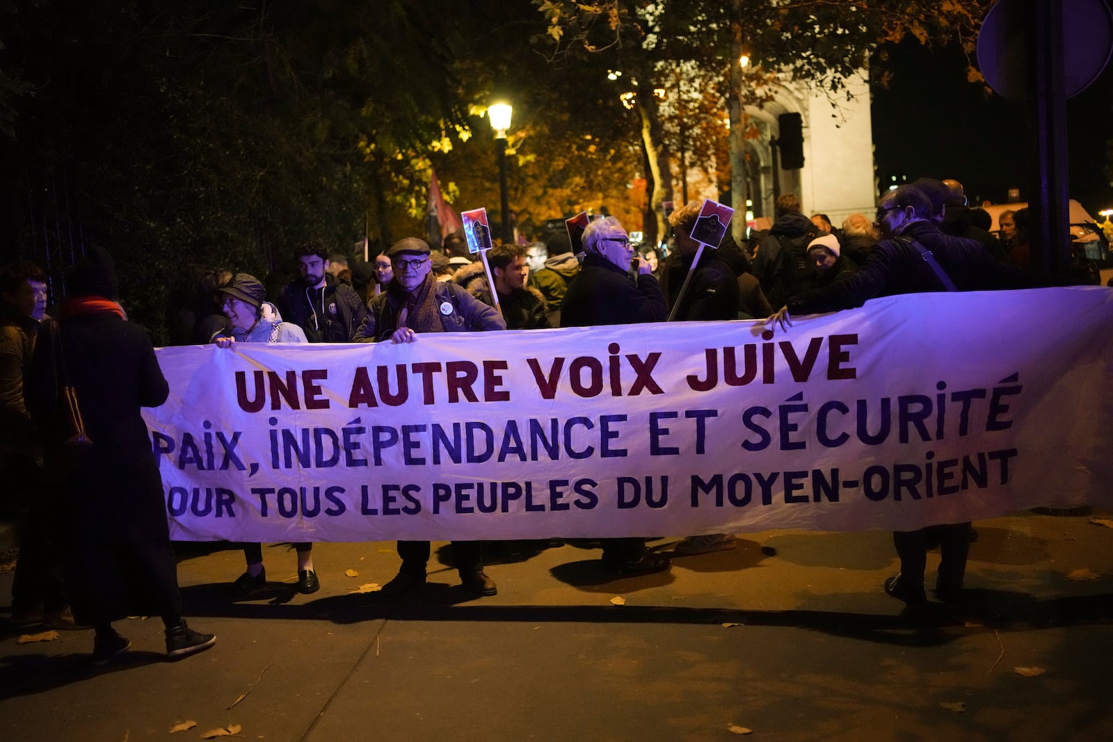 Protestors take part in a rally against the "Israel is Forever" gala organized by far-right Franco-Israeli figures, in Paris, Wednesday, Nov. 13, 2024, on the eve of the UEFA Nations League 2025 soccer match between France and Israel. Banner reads " Another jewish voice. Peace, independence and security for all the peoples of the middle east". (AP Photo/Christophe Ena)