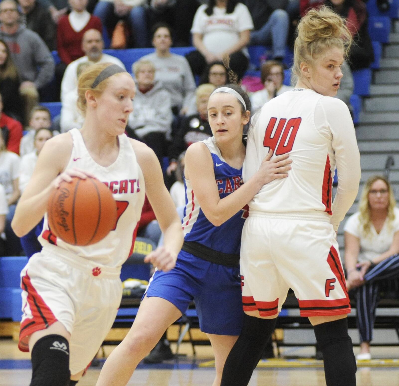 Franklin’s Jordan Rogers gets a pick from teammate Emily Newton and drives toward the basket during Friday night’s Division II regional basketball final at Springfield. Carroll won 57-43. MARC PENDLETON/STAFF