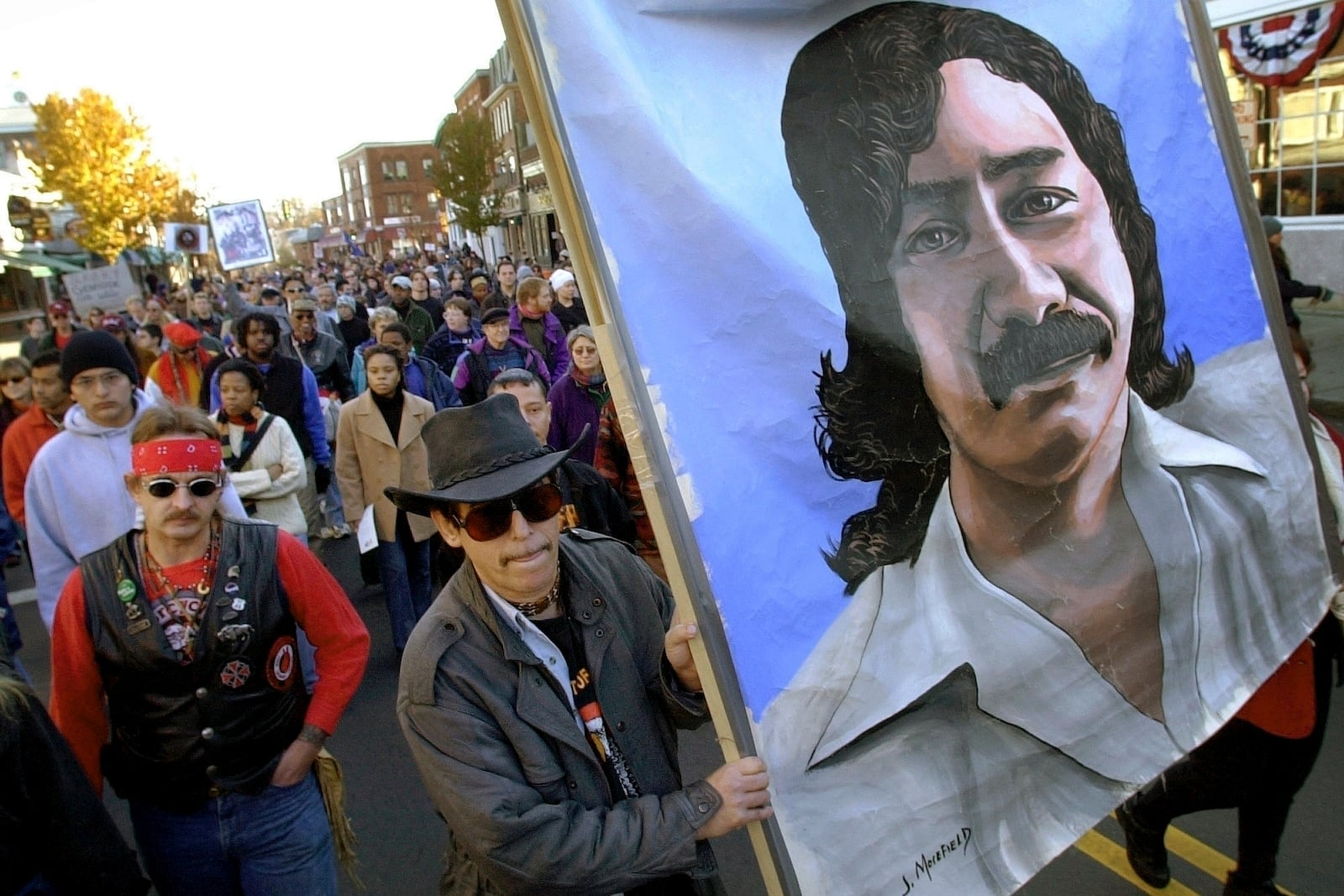 FILE - Marchers carry a large painting of jailed Native American activist Leonard Peltier during a march for the National Day of Mourning in Plymouth, Mass., on Nov. 22, 2001. (AP Photo/Steven Senne, File)