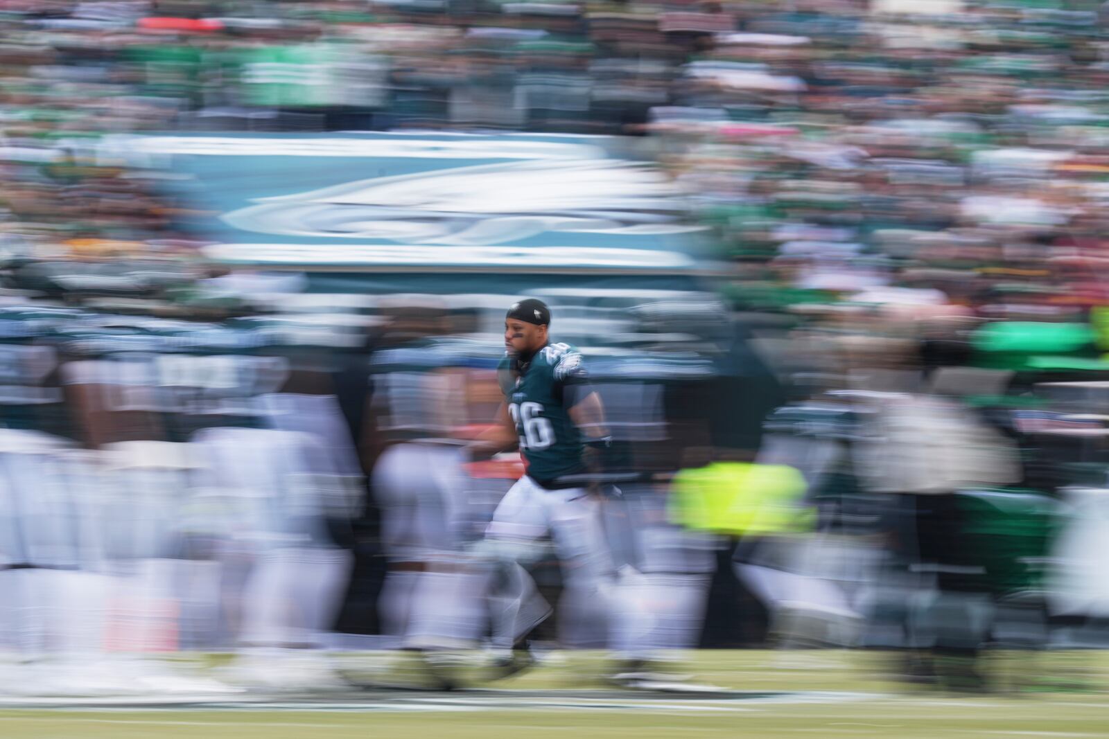 In this image taken with a slow shutter speed, Philadelphia Eagles running back Saquon Barkley is introduced before the NFC Championship NFL football game against the Washington Commanders, Sunday, Jan. 26, 2025, in Philadelphia. (AP Photo/Matt Slocum)