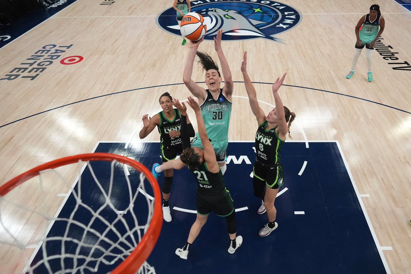 New York Liberty forward Breanna Stewart (30) shoots against Minnesota Lynx forward Napheesa Collier, left, guard Kayla McBride (21) and forward Alanna Smith (8) during the second half of Game 3 of a WNBA basketball final playoff series, Wednesday, Oct. 16, 2024, in Minneapolis. (AP Photo/Abbie Parr)