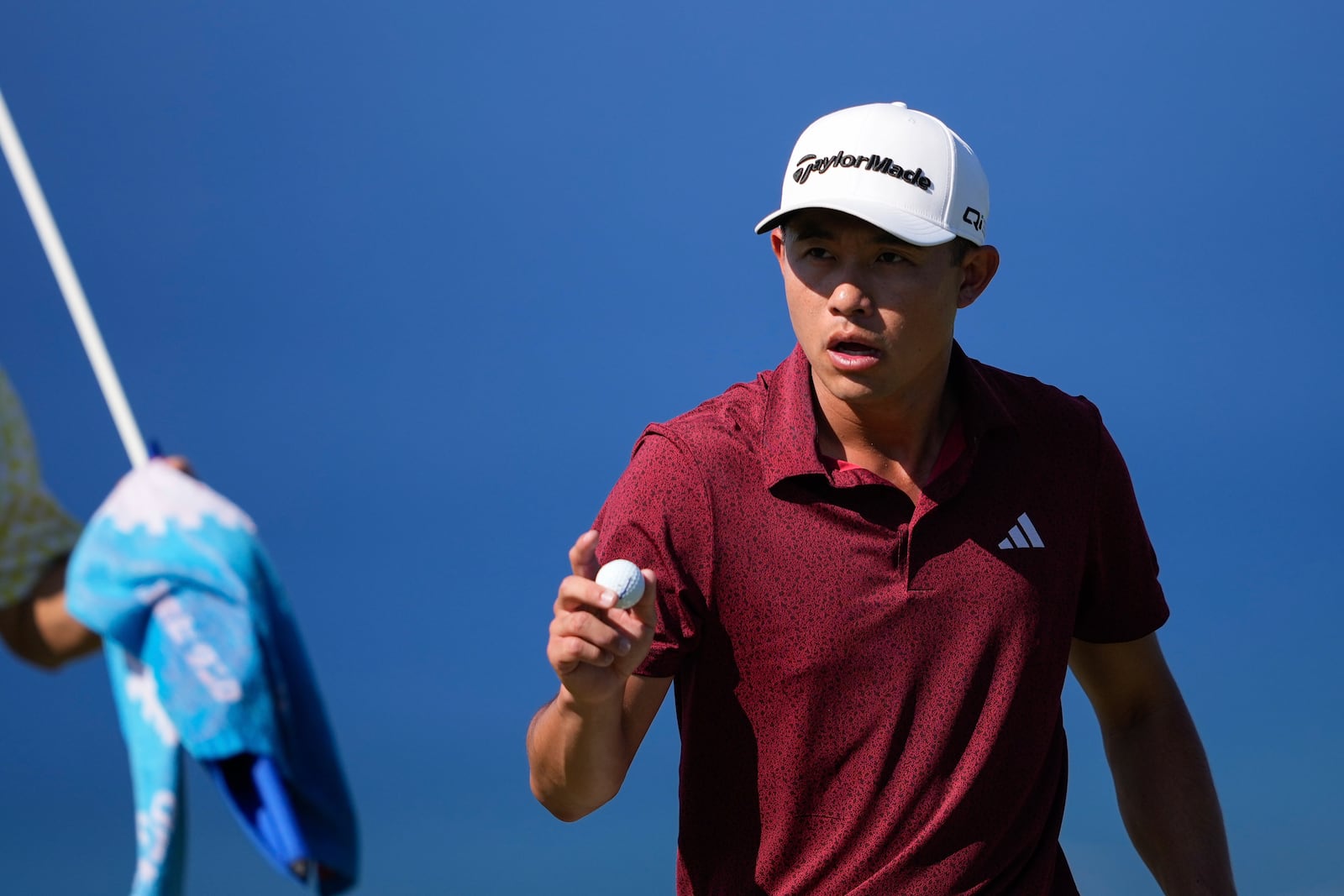 Collin Morikawa acknowledges the gallery after making his shot on the 14th green during the final round of The Sentry golf event, Sunday, Jan. 5, 2025, at Kapalua Plantation Course in Kapalua, Hawaii. (AP Photo/Matt York)