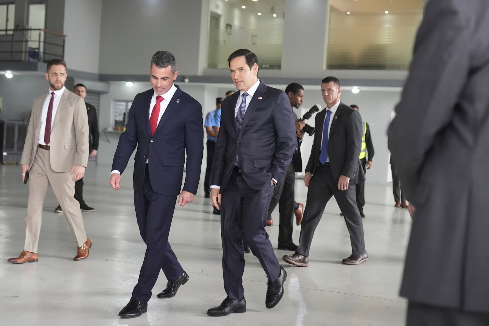 U.S. Secretary of State Marco Rubio, center right, walks with Edwin F. Lopez, the attaché for DHS Homeland Security Investigations, as they walk toward a Venezuelan government airplane that Rubio announced the U.S. is seizing at La Isabela International Airport in Santo Domingo, Dominican Republic, Thursday, Feb. 6, 2025. (AP Photo/Mark Schiefelbein, Pool)