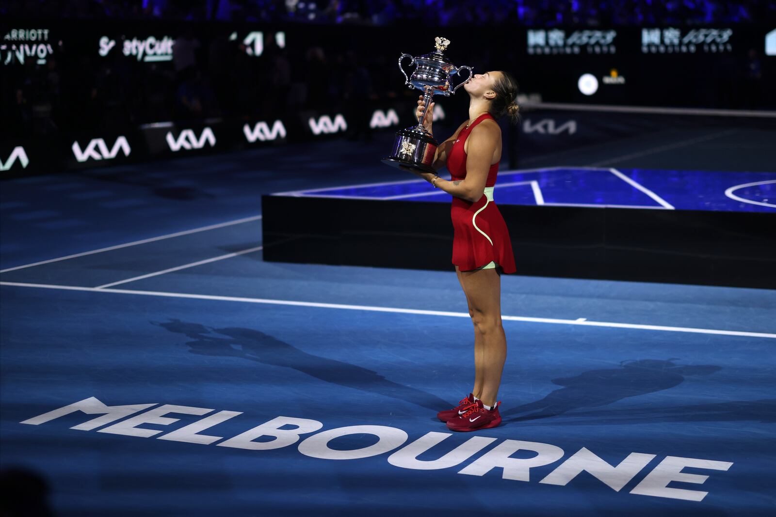 FILE - Aryna Sabalenka of Belarus kisses the Daphne Akhurst Memorial Cup after defeating Zheng Qinwen of China in the women's singles final at the Australian Open tennis championships at Melbourne Park, Melbourne, Australia, Saturday, Jan. 27, 2024.(AP Photo/Asanka Brendon Ratnayake, File)