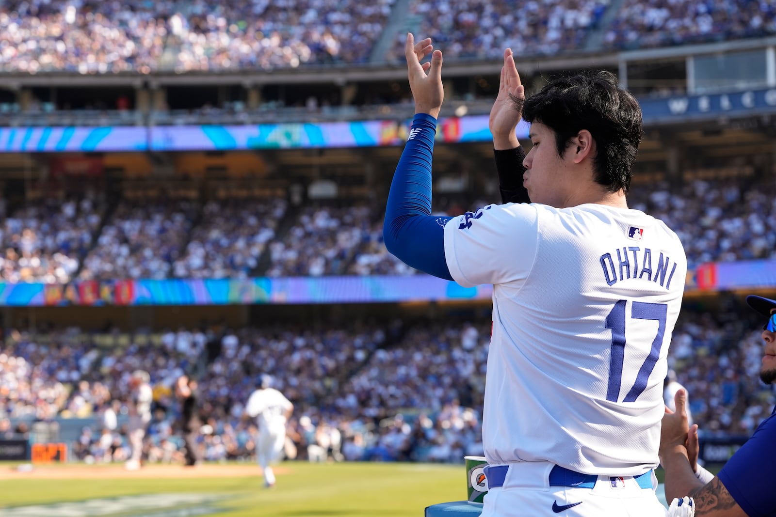 Los Angeles Dodgers' Shohei Ohtani celebrates during the sixth inning in Game 2 of a baseball NL Championship Series against the New York Mets, Monday, Oct. 14, 2024, in Los Angeles. (AP Photo/Gregory Bull)