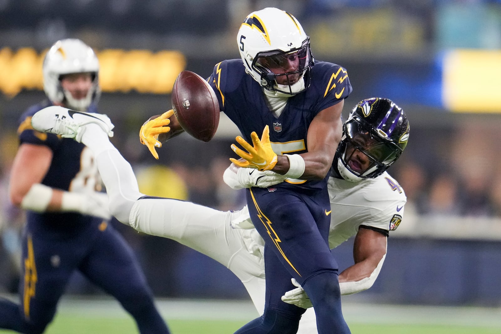 Baltimore Ravens cornerback Marlon Humphrey (44) breaks up a pass intended for Los Angeles Chargers wide receiver Joshua Palmer (5) during the second half of an NFL football game Monday, Nov. 25, 2024, in Inglewood, Calif. (AP Photo/Eric Thayer)