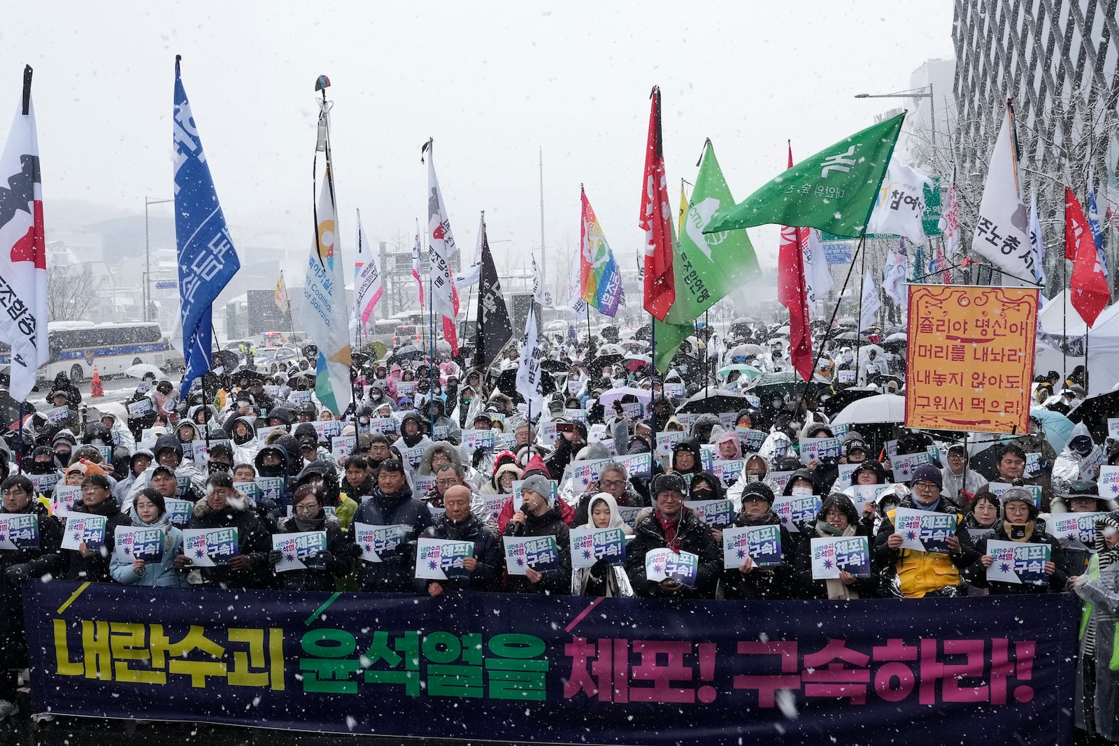 Protesters stage a rally demanding the arrest of impeached South Korean President Yoon Suk Yeol near the presidential residence in Seoul, South Korea, Sunday, Jan. 5, 2025. The letters read "Arrest Yoon Suk Yeol." (AP Photo/Ahn Young-joon)