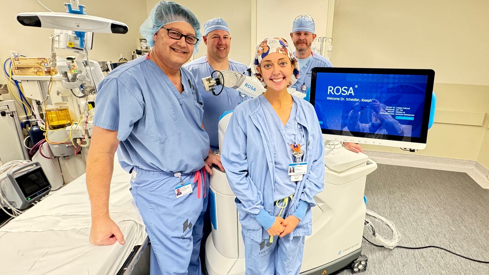 Kettering Health Hamilton is a leader in robotic surgery. Pictured is Dr. Joseph Scheidler (left) and his team with the Rosa system, the tool he uses in all of his knee replacement surgeries. Scheidler said advancements are coming where other joint replacements, such as hips and ankles, can be used with robotic-assisted tools, like the Rosa system. MICHAEL D. PITMAN/STAFF