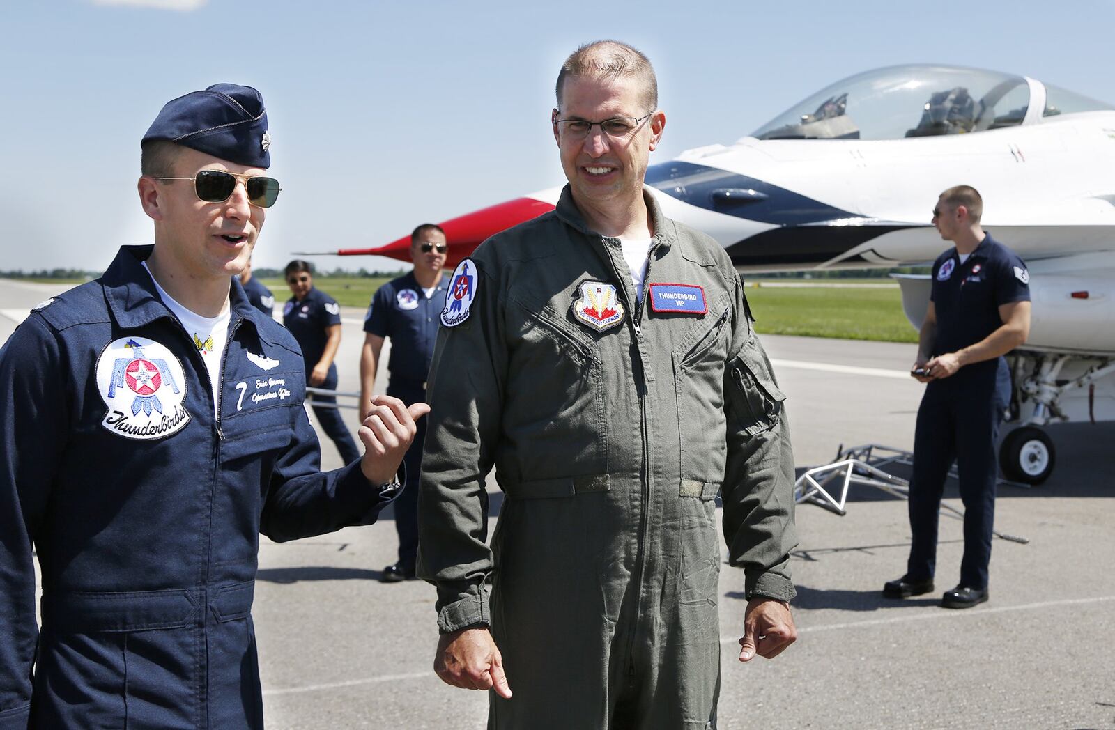 Thunderbird 7 Lt.Col. Eric Gorney talks about Dayton Airport Fire Captain Brian Seidenschmidt after his flight in a Thunderbird F-16 on Friday at the Dayton International Airport before the weekend Dayton Air Show. TY GREENLEES / STAFF