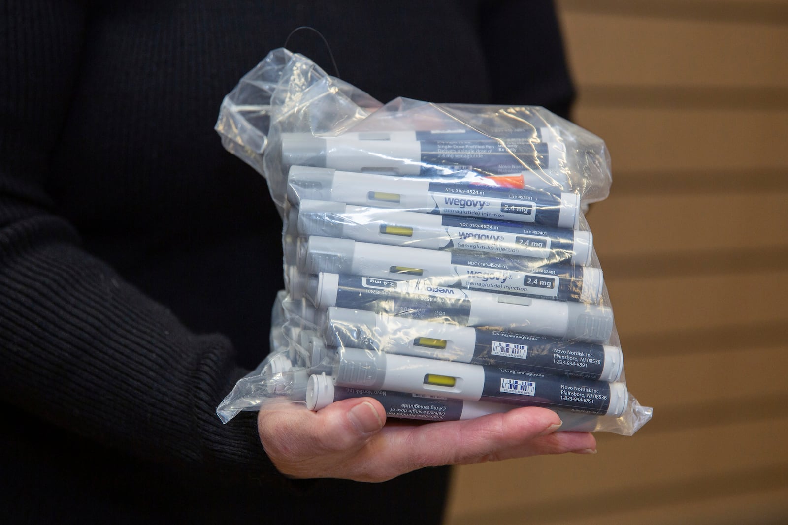 Patient Lory Osborn holds a bag of Wegovy pens used in her treatment at the Medical Weight Management office at West Virginia University in Morgantown, W.Va., Monday, Dec. 2, 2024. (AP Photo/Kathleen Batten)