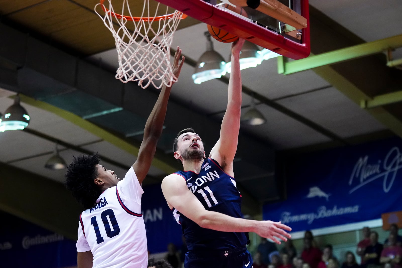 UConn forward Alex Karaban (11) goes to the basket against Dayton guard Hamad Mousa (10) during the first half of an NCAA college basketball game at the Maui Invitational Wednesday, Nov. 27, 2024, in Lahaina, Hawaii. (AP Photo/Lindsey Wasson)