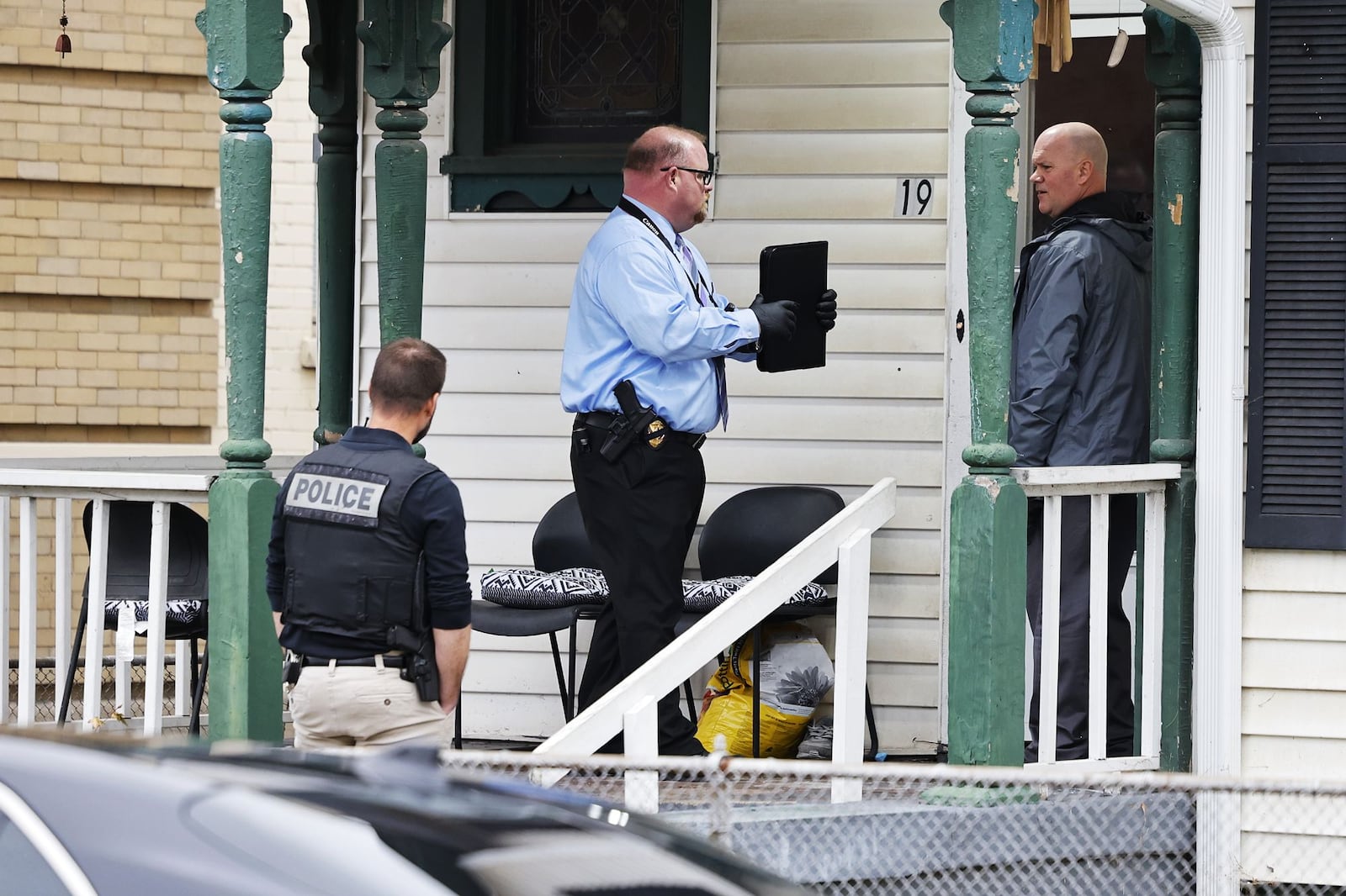 Hamilton Police surrounded a house on North Sixth Street Wednesday looking for a suspect in a shots fired incident on Laurel Avenue. NICK GRAHAM/STAFF