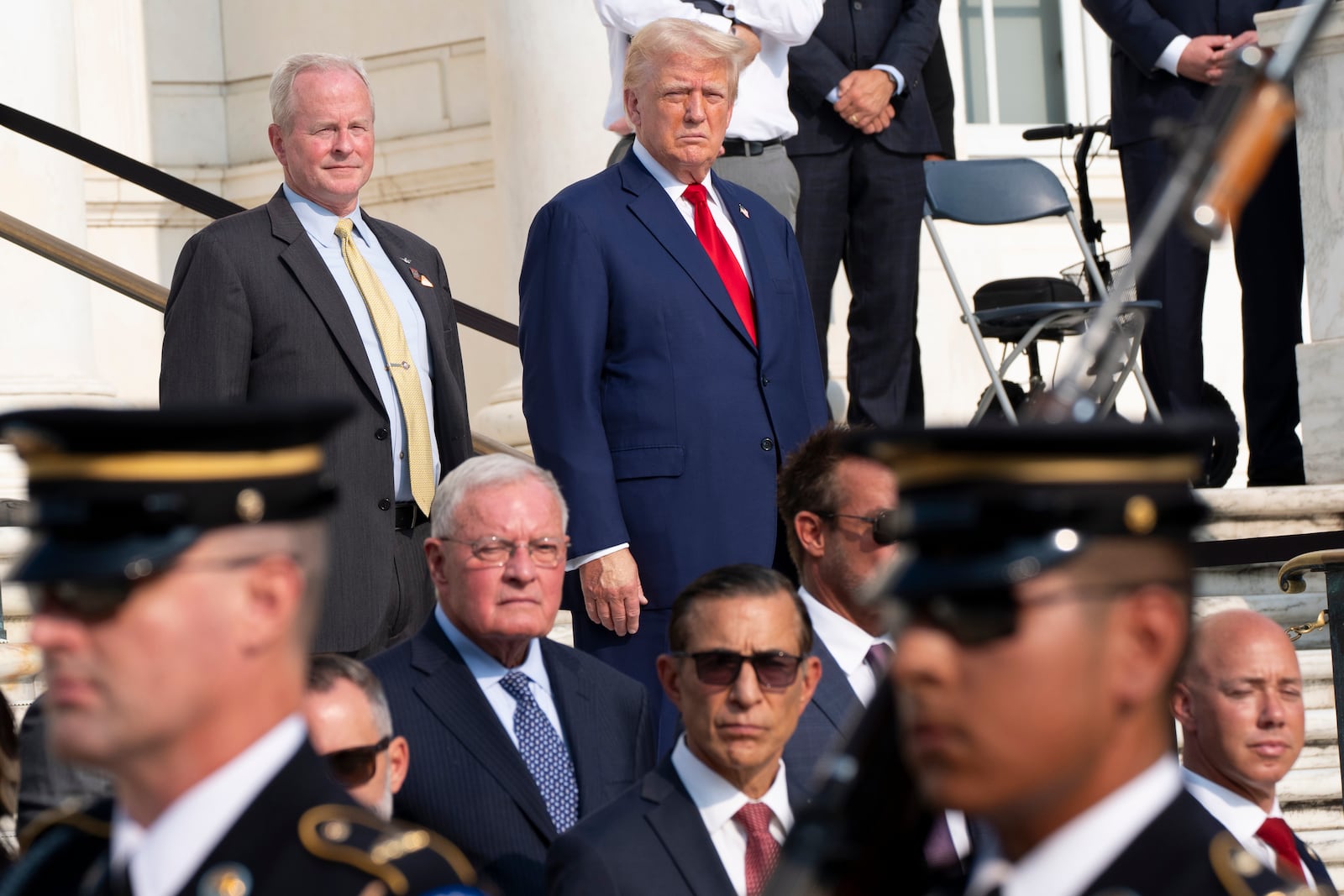 FILE - Republican presidential nominee former President Donald Trump, right, and Bob Quackenbush, deputy chief of staff for Arlington National Cemetery, watch the changing of the guard at the Tomb of the Unknown Solider at Arlington National Cemetery, Aug. 26, 2024, in Arlington, Va. (AP Photo/Alex Brandon, File)