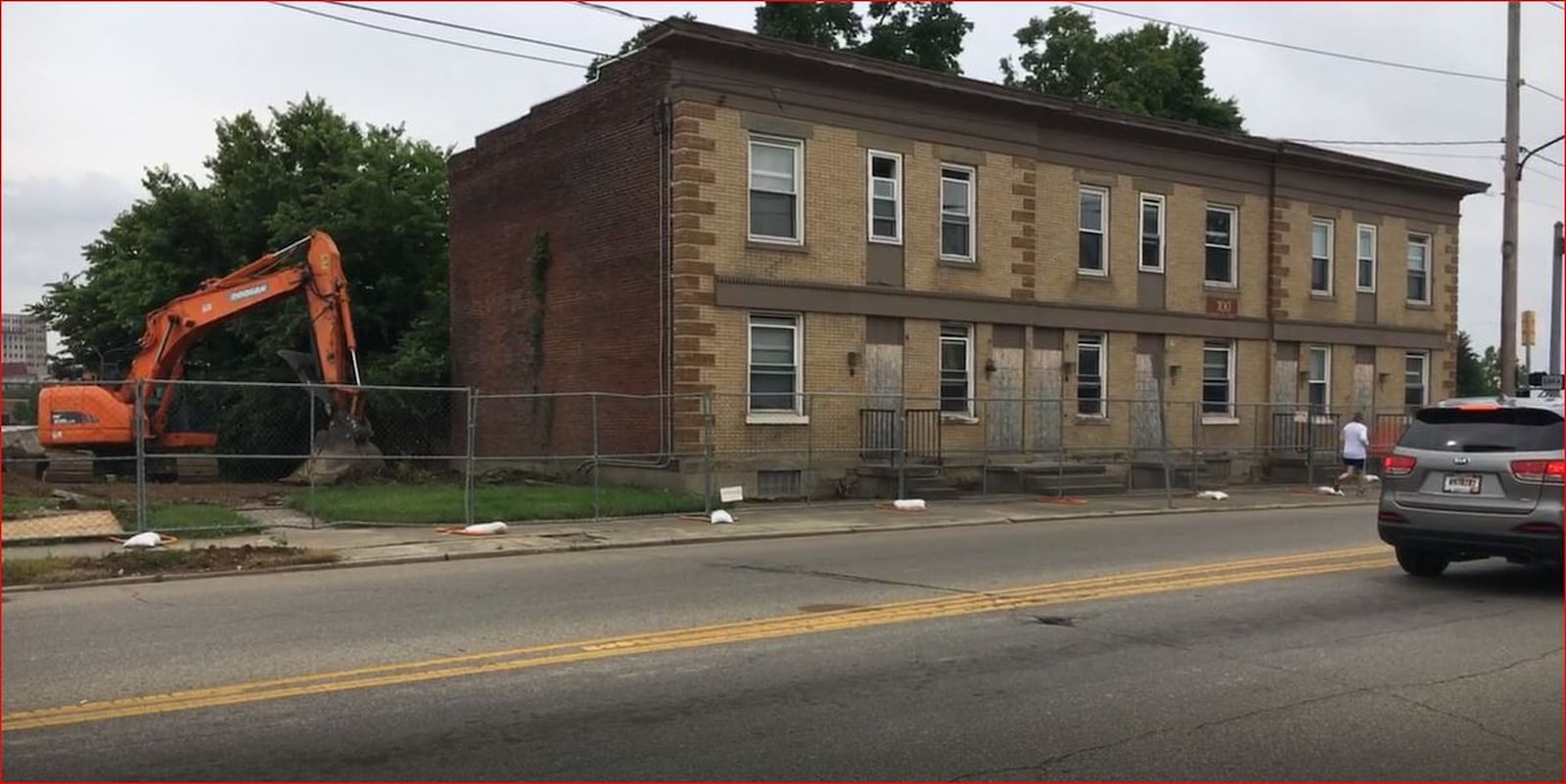 Construction equipment stands where a house at 108 N. B Street used to be. Meanwhile, the apartment next to it, at 100 N. B St., will be razed in coming days to make way for a lane that will take traffic from the High-Main bridge to the Spooky Nook at Champion Mill complex. MIKE RUTLEDGE/STAFF