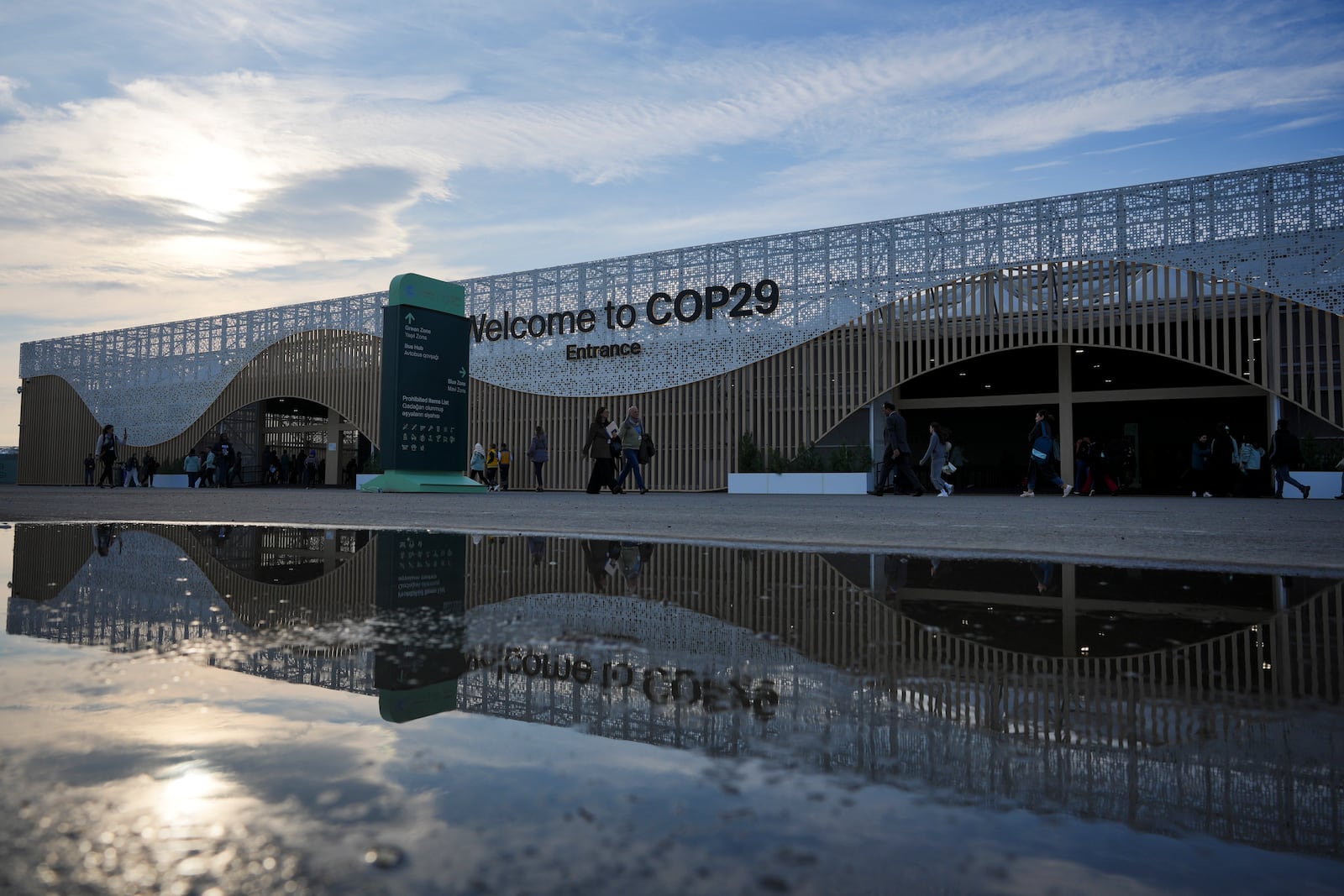 People arrive for the day outside the venue for the COP29 U.N. Climate Summit, Saturday, Nov. 16, 2024, in Baku, Azerbaijan. (AP Photo/Peter Dejong)