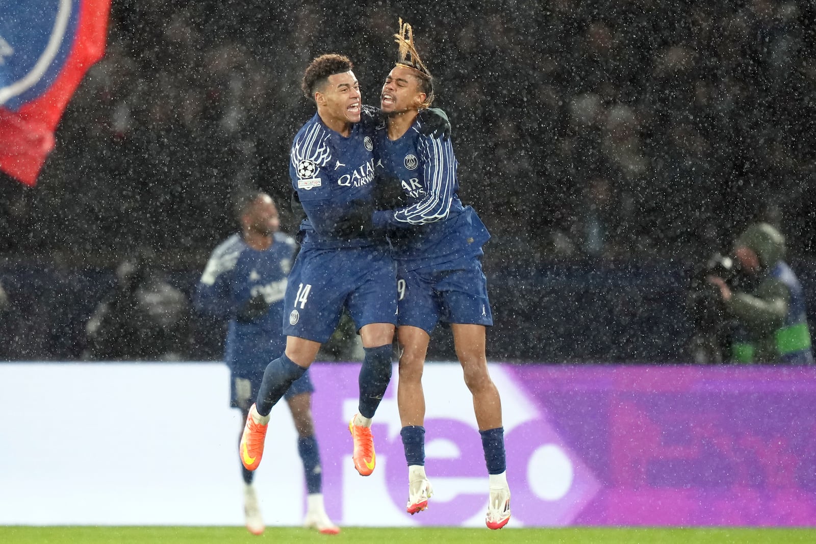 PSG's Bradley Barcola, right, celebrates with Desire Doue after scoring his side's second goal during a Champions League opening phase soccer match between Paris Saint-Germain and Manchester City at the Parc des Princes in Paris, Wednesday, Jan. 22, 2025. (AP Photo/Thibault Camus)