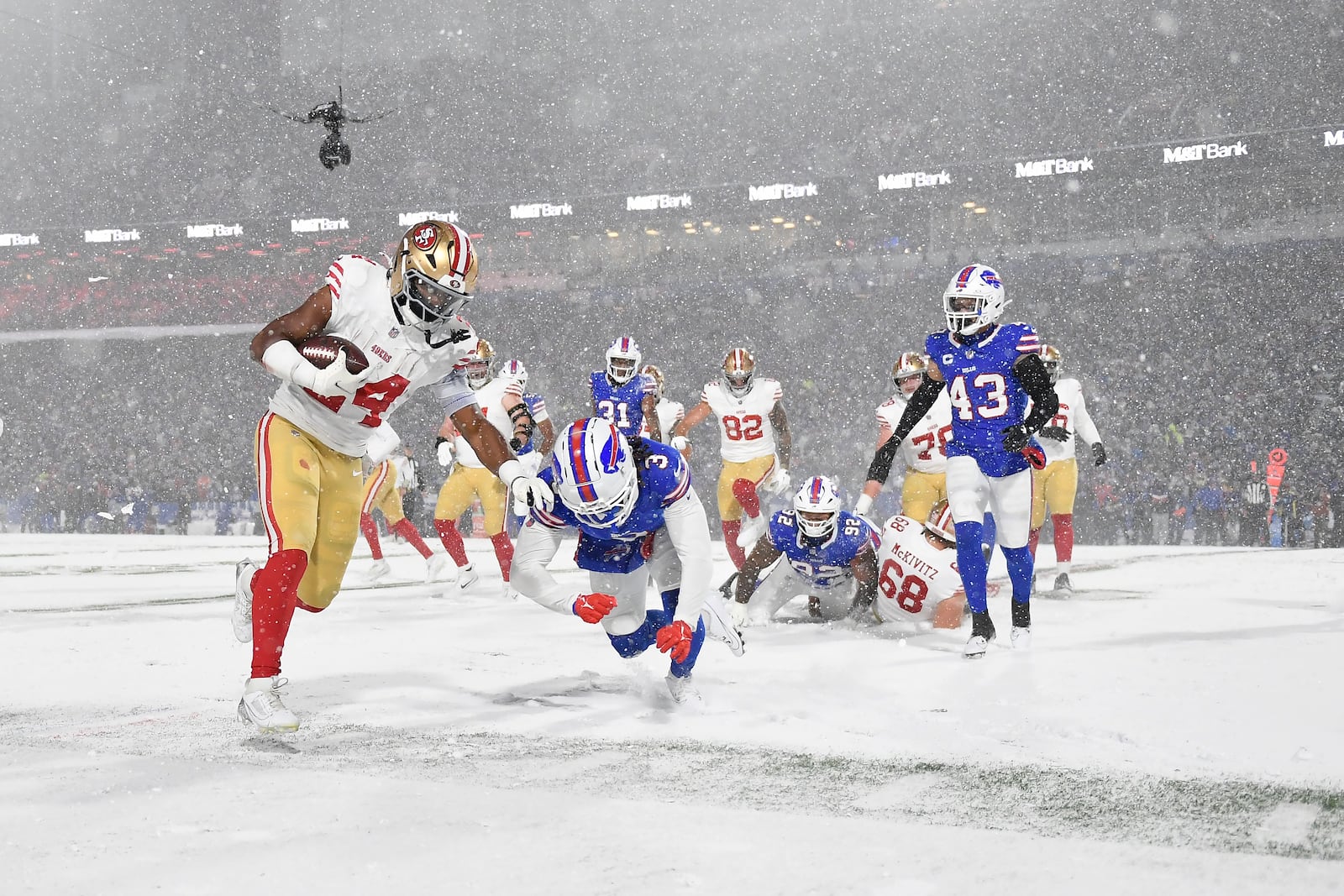 San Francisco 49ers running back Jordan Mason (24) runs against Buffalo Bills safety Damar Hamlin (3) during the second half of an NFL football game in Orchard Park, N.Y., Sunday, Dec. 1, 2024. (AP Photo/Adrian Kraus)