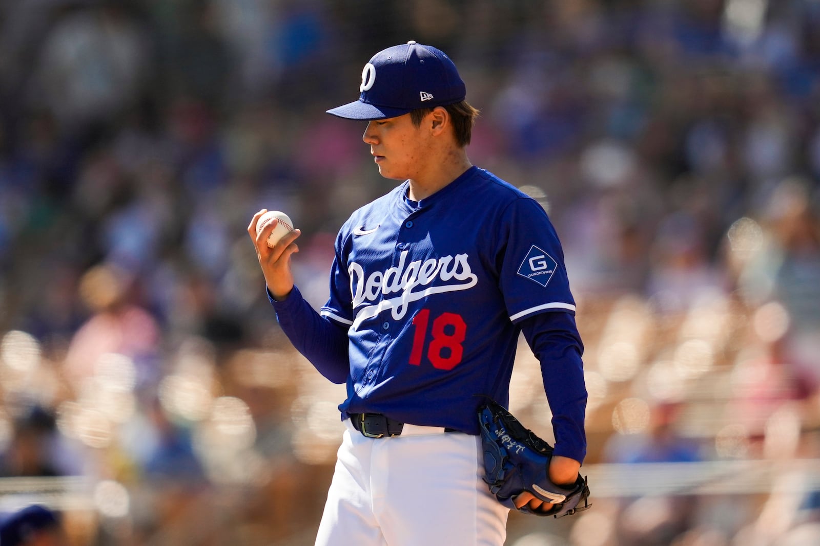 Los Angeles Dodgers pitcher Yoshinobu Yamamoto stands on the mound during the first inning of a spring training baseball game against the Chicago Cubs, Thursday, Feb. 20, 2025, in Phoenix. (AP Photo/Ashley Landis)