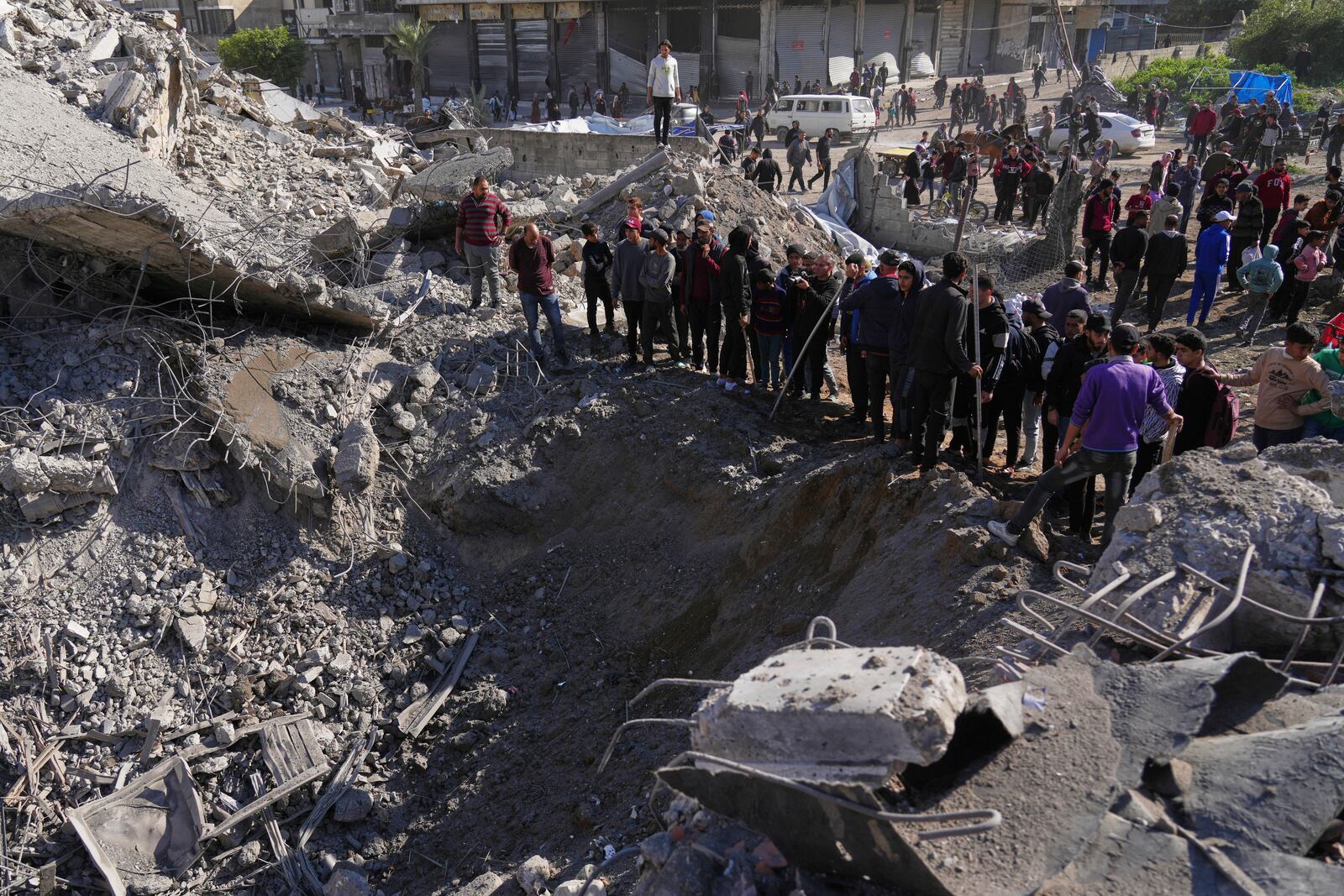 Palestinians inspect the site hit by an Israeli bombardment, in Gaza City on Sunday, March 23, 2025. (AP Photo/Jehad Alshrafi)