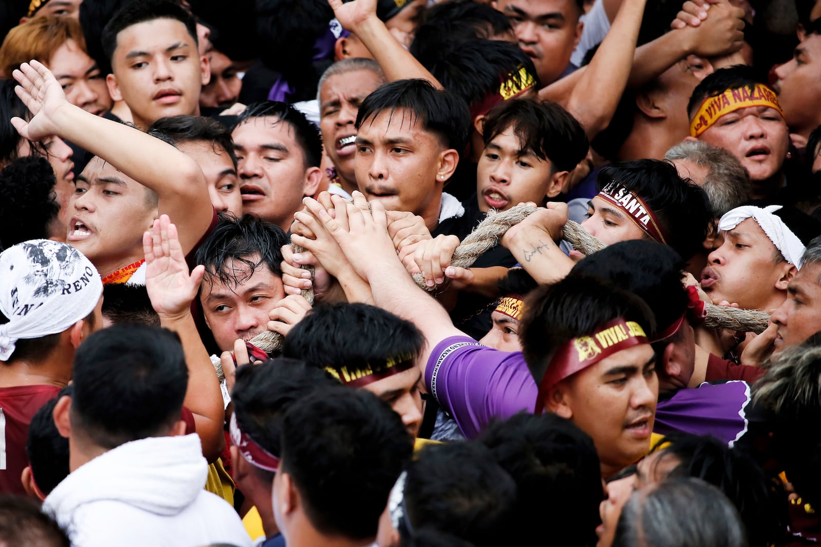 Devotees grab the rope as they pull a glass-covered carriage carrying the image of Jesus Nazareno during its annual procession in Manila, Philippines Thursday, Jan. 9, 2025. (AP Photo/Basilio Sepe)