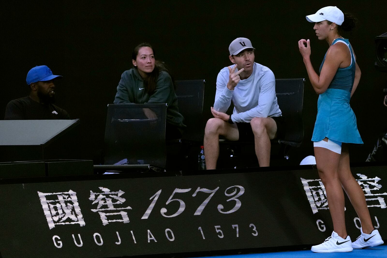 Madison Keys, right, of the U.S. talks with her coaches during her match against Aryna Sabalenka of Belarus during the women's singles final at the Australian Open tennis championship in Melbourne, Australia, Saturday, Jan. 25, 2025. (AP Photo/Ng Han Guan)