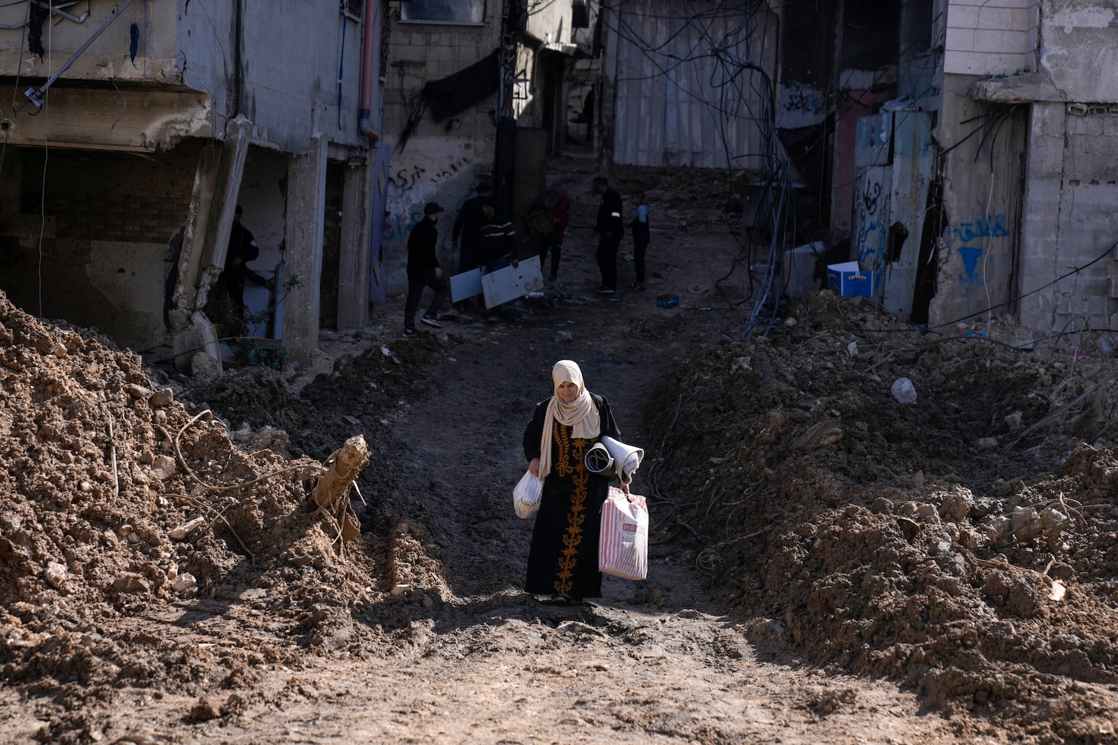 Residents of the West Bank urban refugee camp of Nur Shams evacuate their homes and carry their belongings as the Israeli military continues its operation in the area on Wednesday, Feb. 26, 2025. (AP Photo/Majdi Mohammed)