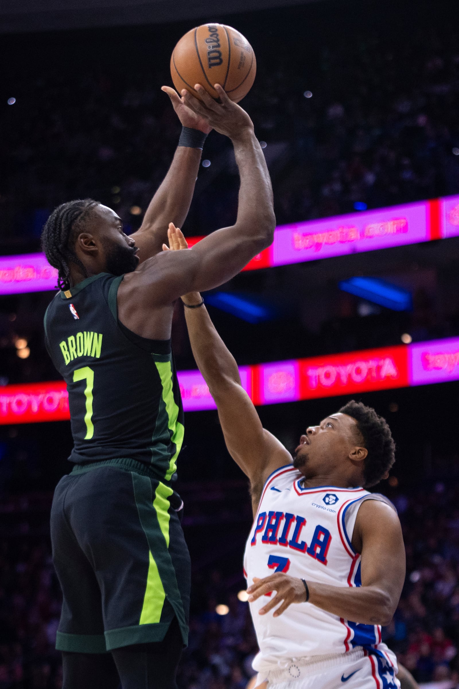 Boston Celtics' Jaylen Brown, left, shoots the ball with Philadelphia 76ers' Kyle Lowry, right, defending during the first half of an NBA basketball game, Sunday, Feb. 2, 2025, in Philadelphia. (AP Photo/Chris Szagola)