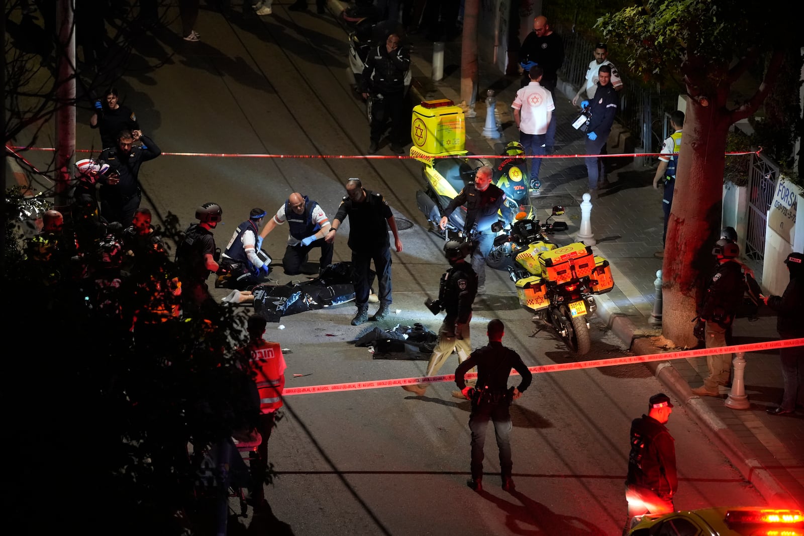 Israeli police check the body of a suspected attacker at the scene of a stabbing attack in Tel Aviv, Israel, Tuesday, Jan. 21, 2025. (AP Photo/Tomer Appelbaum /Haaretz)