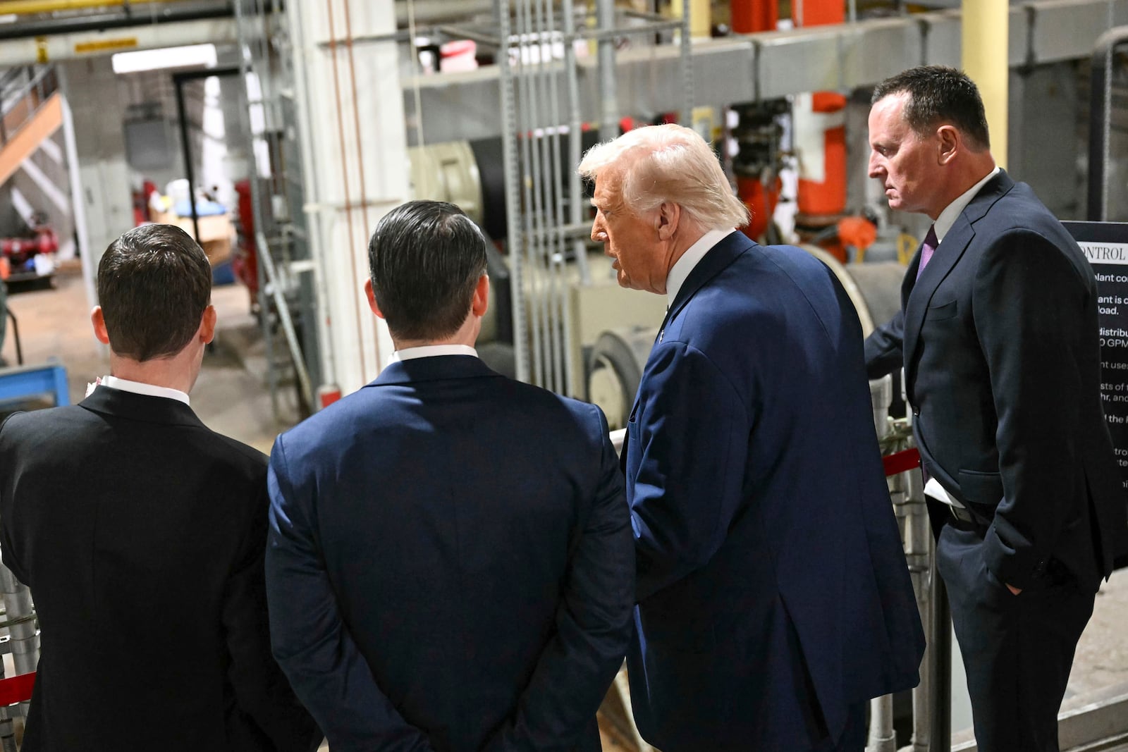 President Donald Trump talks with Kennedy Center Board of Trustees president Richard Grenell, right, as he tours the John F. Kennedy Center for the Performing Arts in Washington, Monday, March 17, 2025. (Jim Watson, Pool via AP)