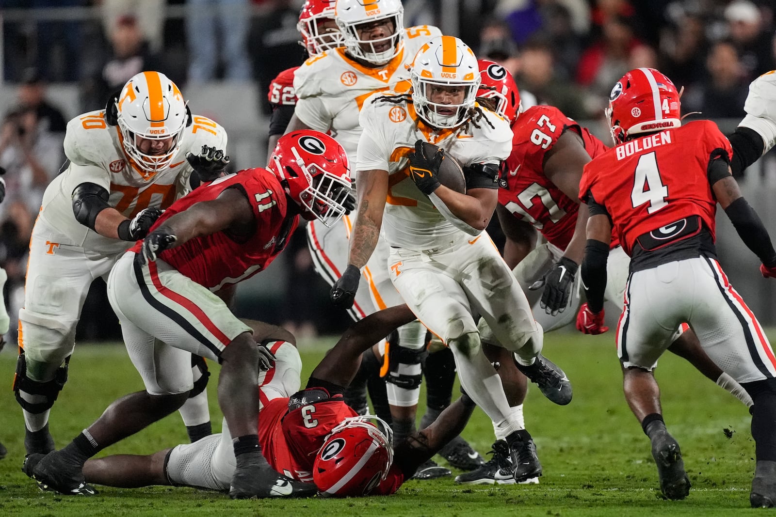 Tennessee running back Peyton Lewis (27) tries to brel free from Georgia's CJ Allen (3) and Jalon Walker (11) during the first half of an NCAA college football game, Saturday, Nov. 16, 2024, in Athens, Ga. (AP Photo/John Bazemore)