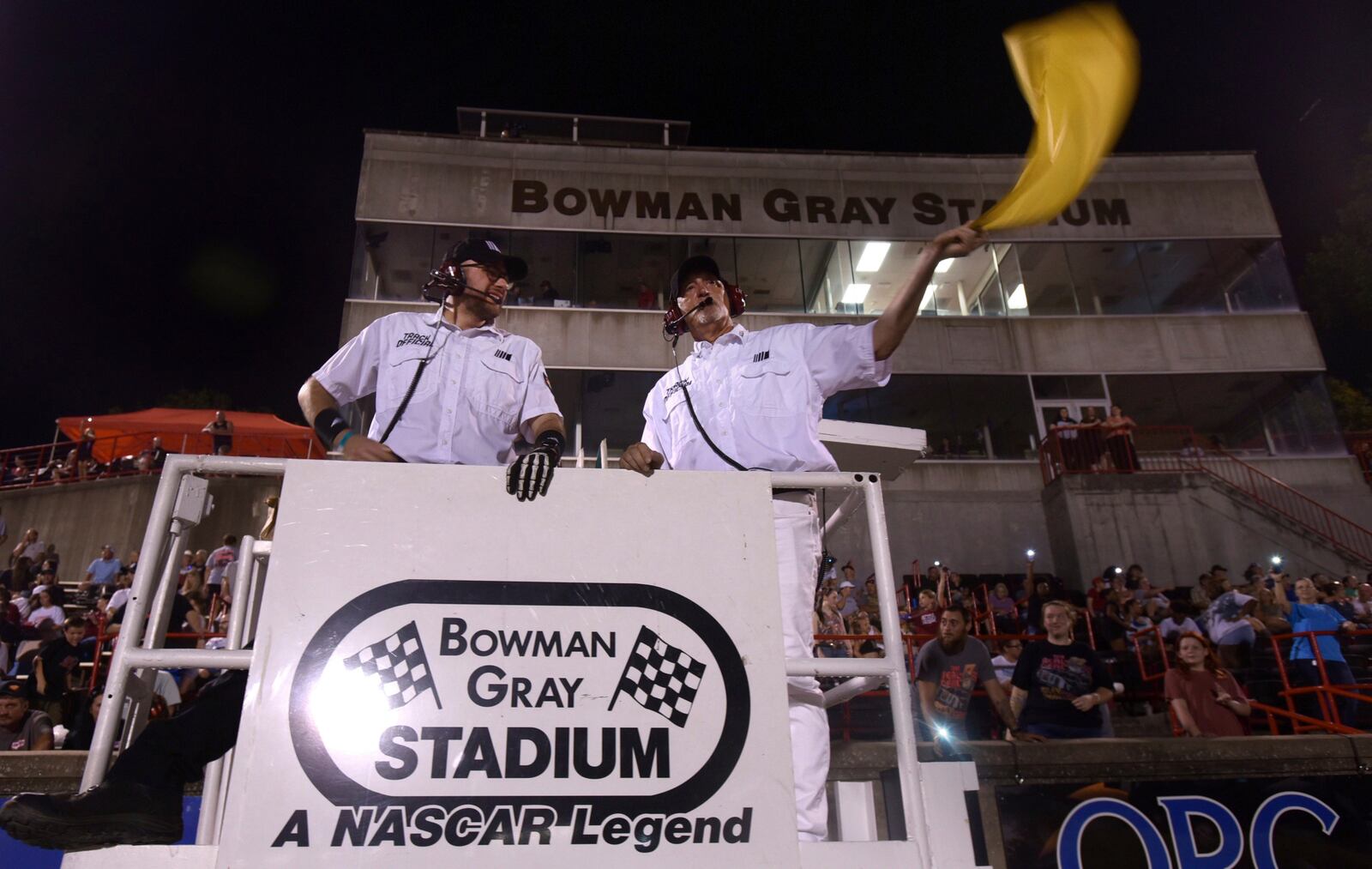 FILE - Flagmen Matt Garrison, left, and Randy Smith prepare for their next race, Saturday, June 15, 2024 at Bowman Gray Stadium in Winston-Salem, N.C. (Walt Unks/Winston-Salem Journal via AP, File)