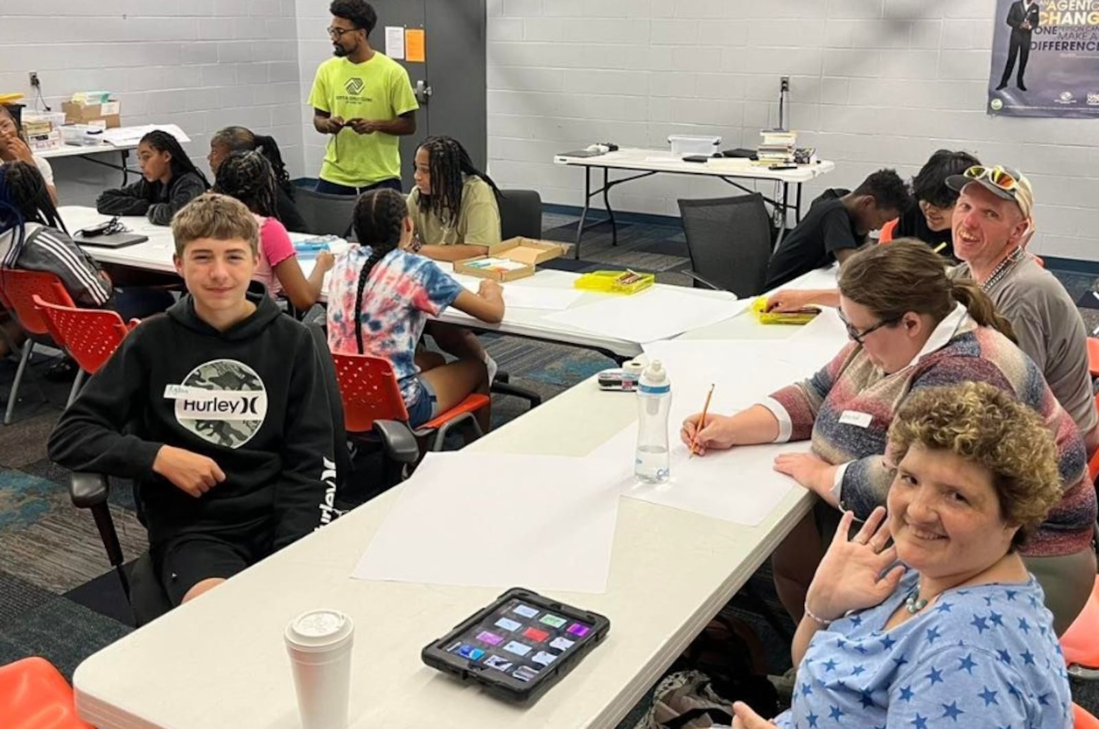 Artists with disabilities from InsideOut Studios and teens from the Bots & Girls Club in Hamilton work together to create a mural at the Teen Center. CONTRIBUTED