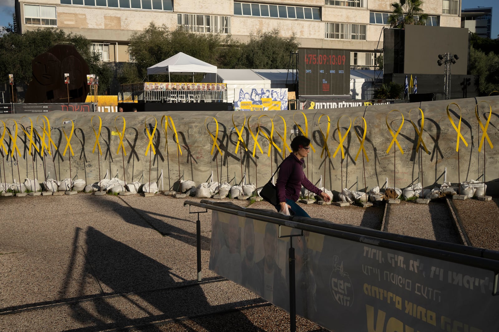 Yellow ribbons for hostages held by the Hamas militant group in the Gaza Strip line a replica of a Gaza tunnel in Tel Aviv, Israel, Friday, Jan. 24, 2025. (AP Photo/Maya Alleruzzo)