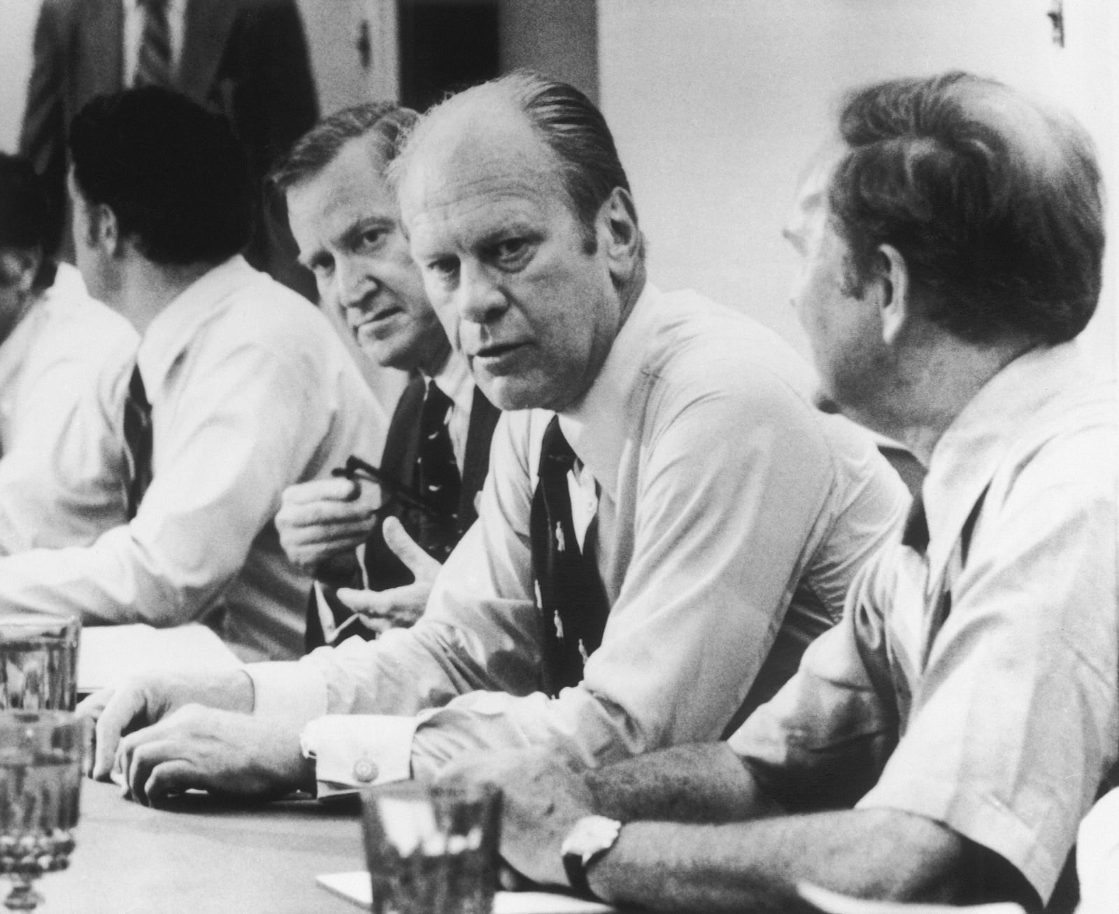 FILE - President Gerald Ford looks over the conference table during a shirtsleeve, closed door meeting with Environmental Protection Agency officials in Cincinnati, July 3, 1975. (AP Photo/Barry Thumma, File)